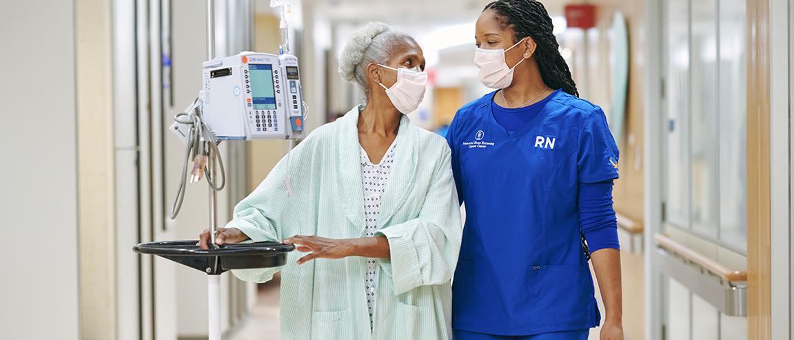 MSK nurse and patient walking together, looking at each other and smiling