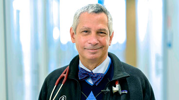 Smiling doctor with a bow tie and stethoscope.
