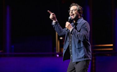 Nick Kroll performing onstage at Comedy vs Cancer 2024 