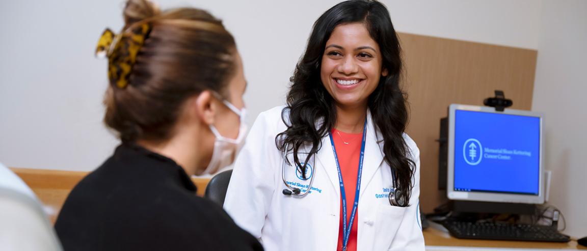 Smiling doctor treating pancreatic cancer patient