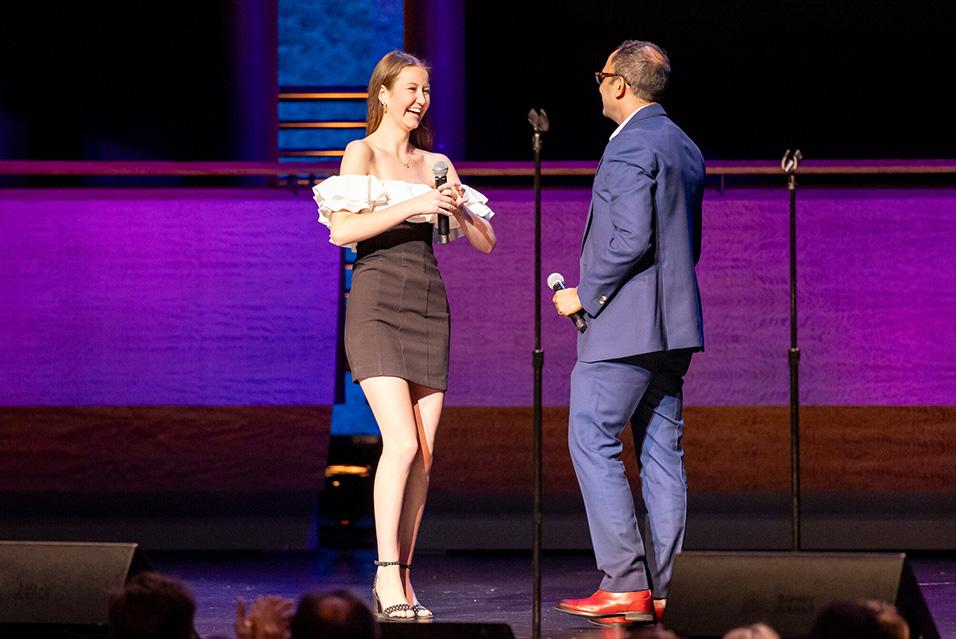 Scarlett James surprising Dr. Shukla on stage at Comedy vs Cancer 2024. 