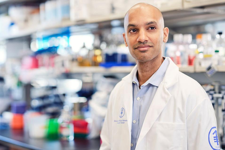 MSK Lymphoma specialist Santosh Vardhana, MD, PhD, stands in a lab coat looking off camera. 