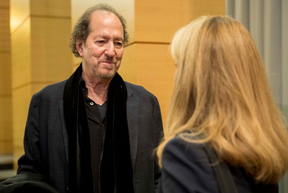 MSK patient and jazz musician Michael Wolff, dressed in black and standing, smiles in conversation.